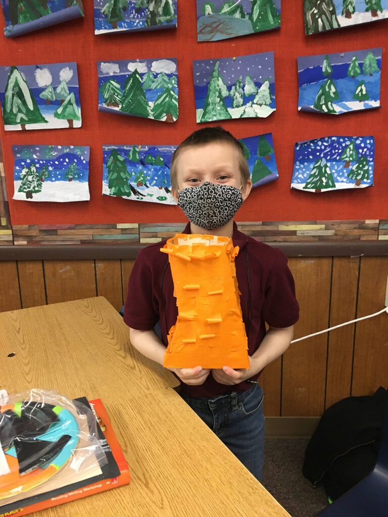 A student with finished artwork